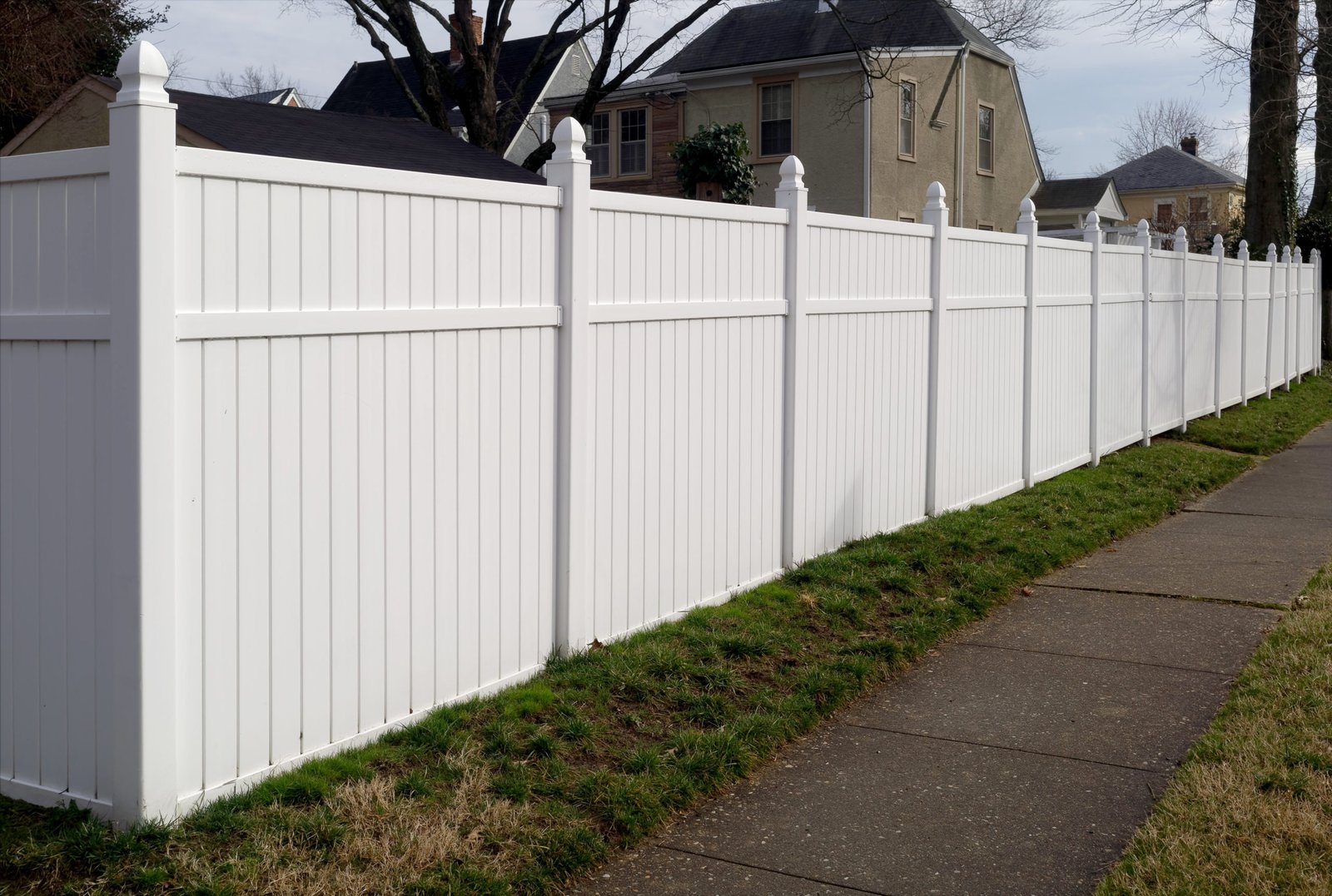 White vinyl fence in residential neighborhood. PVC Fence